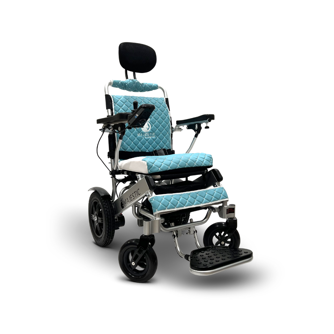 The ComfyGo MAJESTIC IQ-9000 is a blue and white electric wheelchair featuring a quilted seat, backrest with headrest, armrests, footrest, a digital joystick on the right armrest, automatic reclining, black wheels, and a silver frame for comfort and style.
