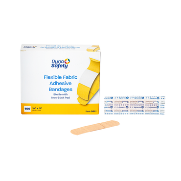 A box of Dynarex DynaSafety Adhesive Fabric Bandages is shown with one wrapped and one unwrapped beige bandage. The box contains 100 sterile bandages with non-stick pads for reliable wound protection.