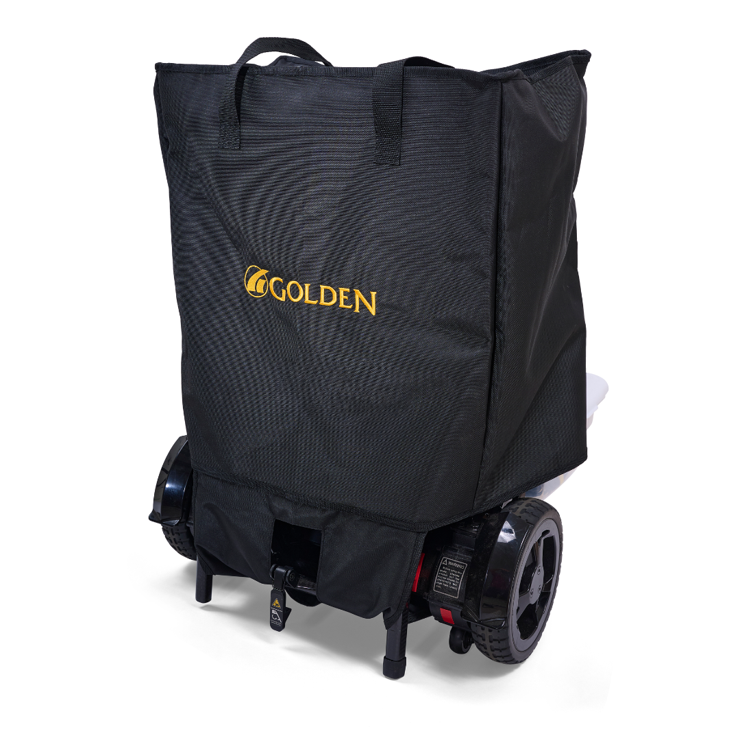 A black fabric cover with a yellow Golden Tech logo is draped over the back of the Golden Tech GP302 Carbon Fiber Cricket Power Wheelchair (33 lbs), concealing the seat and most areas except for the rear wheels.