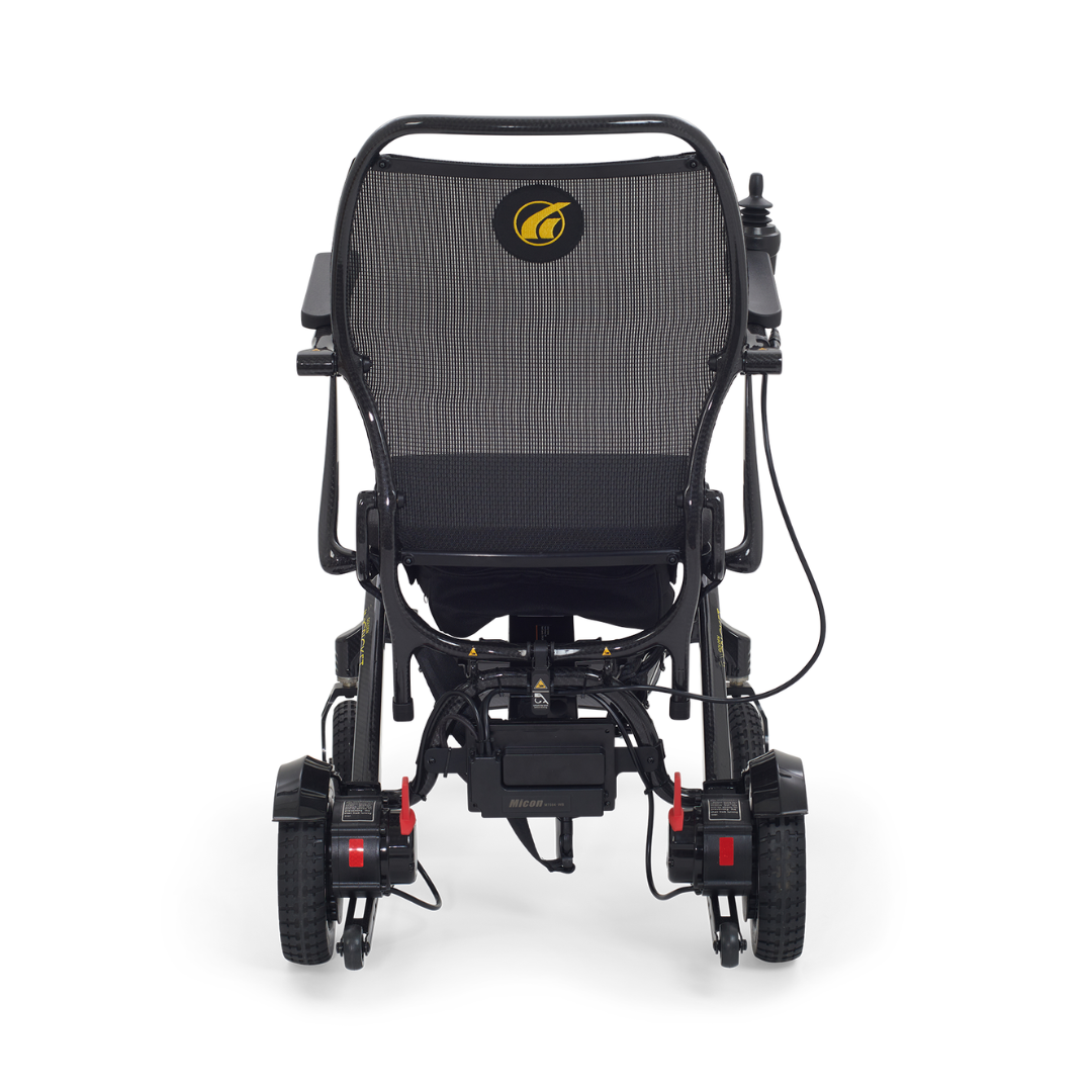 Rear view of the Golden Tech Carbon Fiber Cricket Power Wheelchair, weighing only 33 lbs. It features a mesh backrest, two large rear wheels, two smaller front wheels, a control joystick on one armrest, and a sleek modern design with a durable carbon fiber frame.