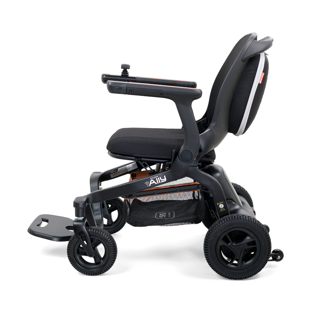 The Golden Tech Ally Folding Power Wheelchair features a black padded seat, armrests, footrest, joystick control on the right armrest, and sturdy wheels. It offers reliable mobility both indoors and outdoors and can be managed via a mobile app.