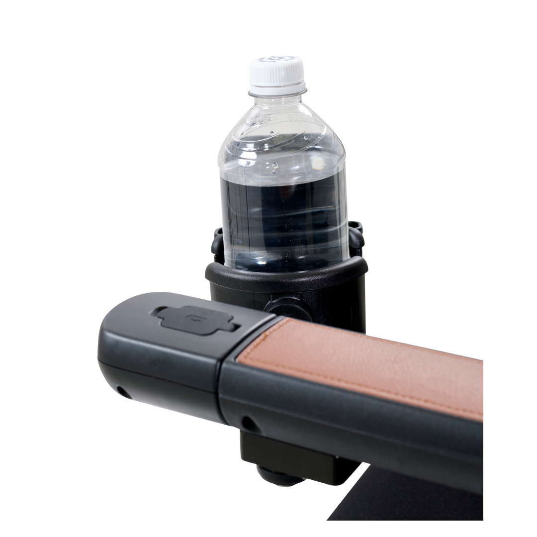A bottle of water rests securely in the black cup holder on the armrest of a beige and black chair, highlighting the sleek design of Golden Tech Accessories for The Ally Powerchair.