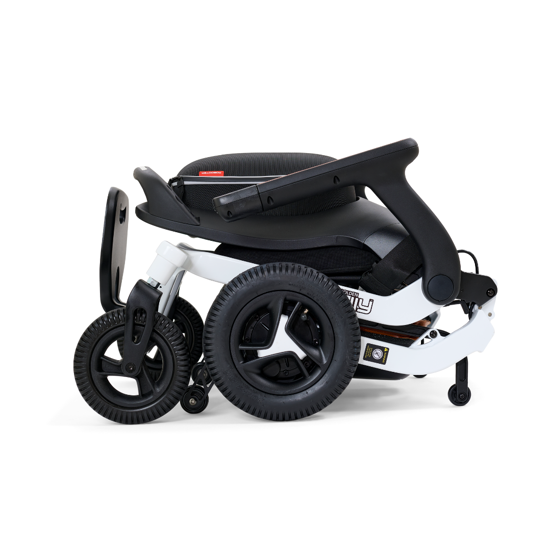 The Golden Tech Ally Folding Power Wheelchair features a sleek, folded black and white design with three wheels, a black handlebar, and a white frame with black seating. Its the ideal travel companion offering a compact appearance akin to a foldable power wheelchair.