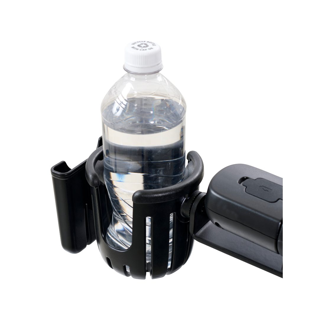 A transparent plastic water bottle rests in a black cup holder with slotted sides and an integrated phone holder, attached to a wheelchair armrest. Its part of the Golden Tech Accessories for The Ally Powerchair.