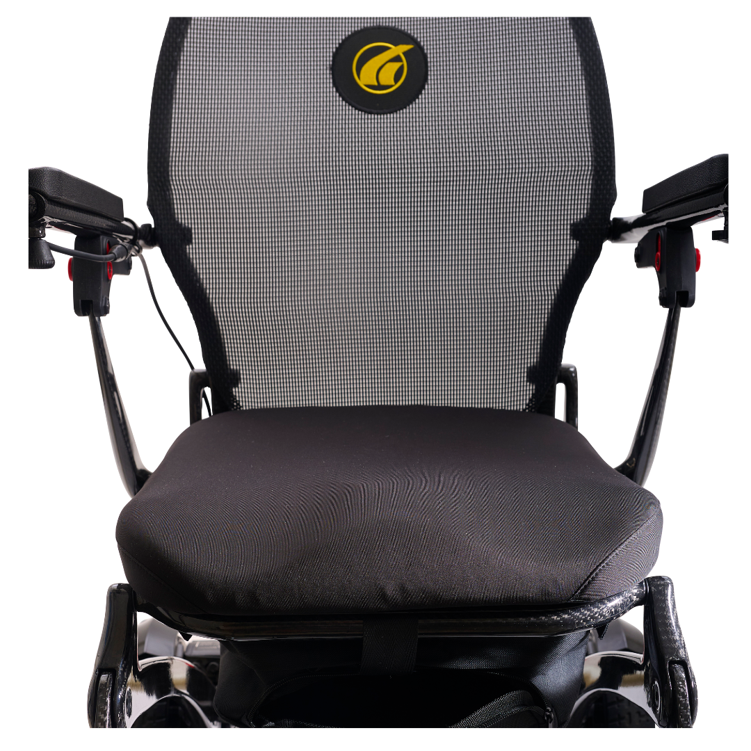Close-up of the Golden Tech Carbon Fiber Cricket Power Wheelchair—just 33 lbs—with black mesh seat and backrest, armrests on both sides, and a yellow logo on the backrest.