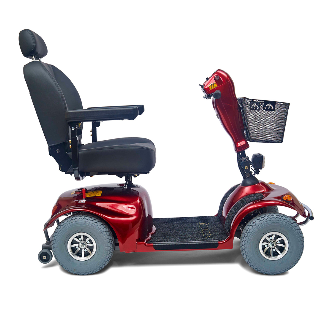 The Golden Tech Avenger HD Bariatric Mobility Scooter is a red, four-wheeled scooter with a black cushioned seat and backrest. It features a front tiller with a basket and is designed for outdoor use on rugged terrain.