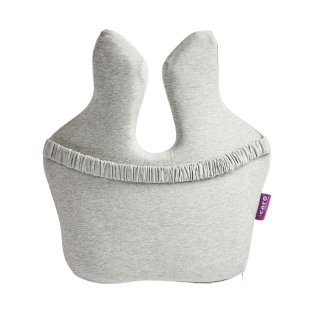 The iCare Reform Full Back Support is a light gray, uniquely shaped cushion with two upright prongs, a gathered seam, and ergonomic charcoal-infused ActiveX foam. It features a small purple tag with white text on the right edge.