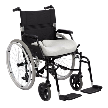 A black manual wheelchair with large rear wheels, small front wheels, padded armrests, adjustable footrests, and an iCare Reform Seat Support Cushion - Targeted Pressure Relief in light gray for ergonomic support.