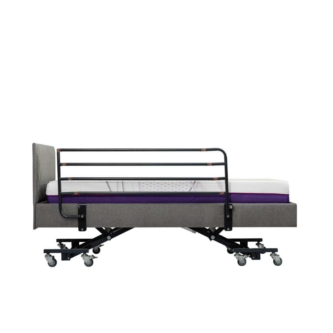 The iCare Medical Bed Safety Rails are shown installed on a modern adjustable hospital bed with a grey upholstered frame, purple mattress, black side rail, and caster wheels, pictured from the side against a white background.