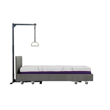 The icare Medical Freestanding Pull-Up Bar is shown against a plain white background, featuring a grey upholstered hospital-style bed with wheels and a patient lift pole for mobility and transfers.
