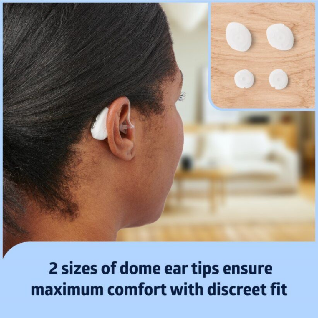A person wears the Medline Rechargeable Digital OTC Hearing Aid with a white dome ear tip. Inset shows four white dome ear tips in two sizes on a wooden surface. Text: Two sizes offer comfort, noise reduction, and a discreet fit.