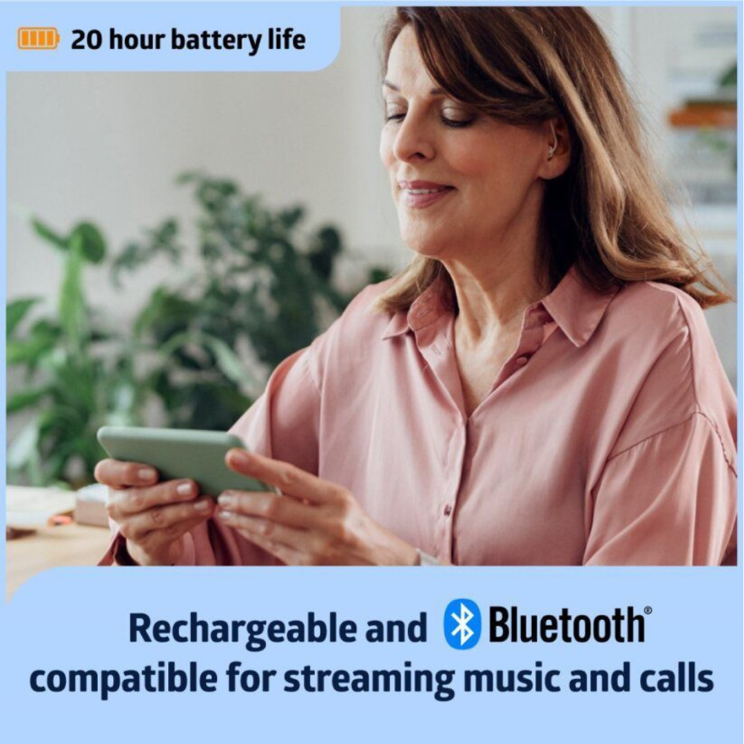A woman in a pink blouse smiles while using Medline Bluetooth Rechargeable OTC Hearing Aids - Behind The Ear. Text highlights “20 hour battery life” and notes they’re clinically designed for clarity, rechargeable, and perfect for streaming music and calls.