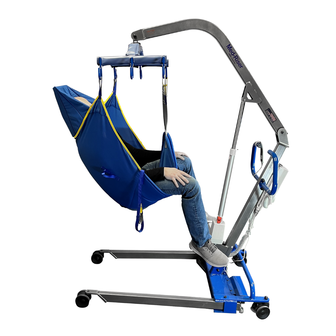 A person sits in a blue sling secured to the Med-Mizer MedRiser 600 Patient Lift, a fully electric lift with wheels designed for safe patient handling and mobility assistance.