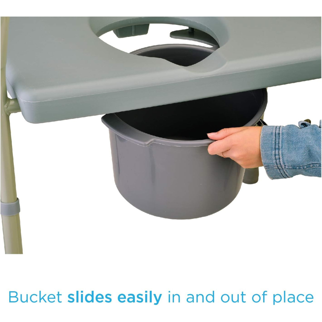 Using the Nova Bariatric Bedside Commode with Extra Wide Seat, a person effortlessly demonstrates the drop-arm feature by smoothly sliding a gray bucket in and out of the cut-out section beneath the green seat, supported by sturdy metal legs.