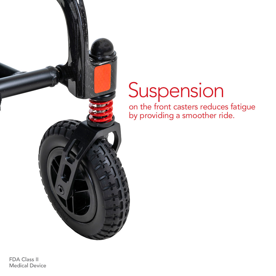 Close-up of a black caster wheel with a red suspension spring attached to a frame, labeled an FDA Class II Medical Device. Suspension on front casters reduces fatigue by providing a smoother ride, perfect for your Pride Mobility Jazzy® Carbon Ultralite Powerchair.