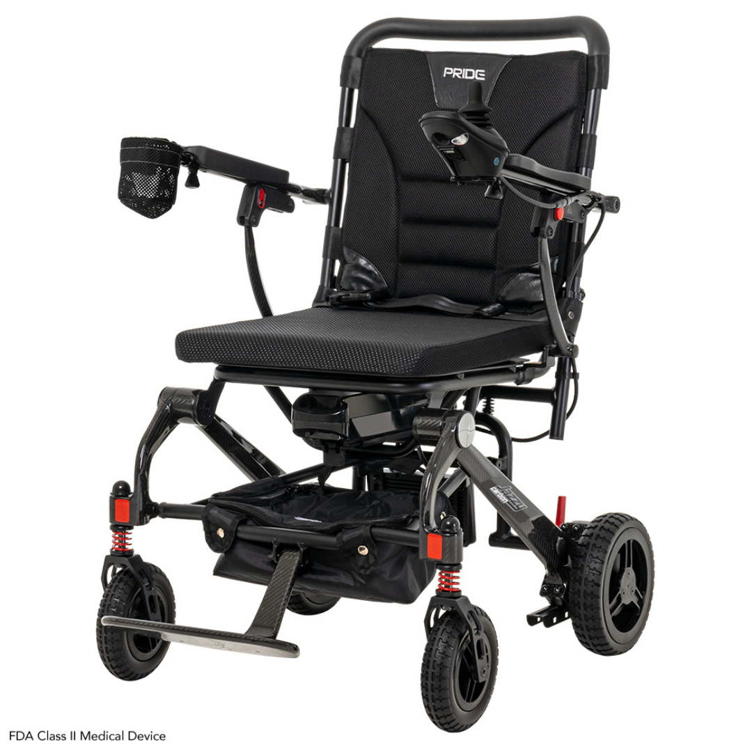 The Pride Mobility Jazzy® Carbon Ultralite Powerchair sports a sleek black frame and seat, removable joystick with USB charger, compact design, small front basket, footrest, red suspension springs on four wheels, and features an airline-compliant lithium battery. Ideal for any journey.