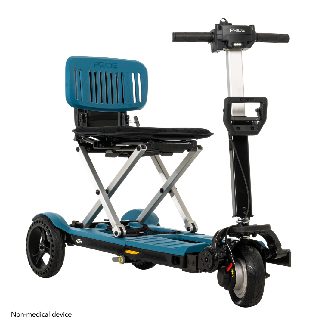 The Pride Mobility i-Go™ Portable Travel Scooter is ultra-compact, featuring a blue seat, black frame, and a three-wheel design. It includes Feather-Touch Disassembly, a small handlebar control panel, and convenient foldability. A label states Non-medical device at the bottom-left.