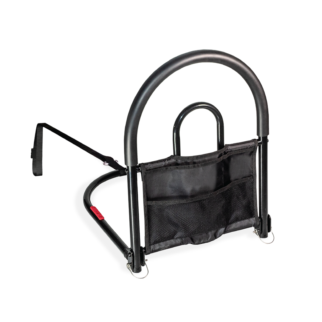 The Stander Bed Rail Advantage Traveler is a black metal portable bed safety rail with a curved bariatric support handle, mesh storage pouch, and a horizontal arm that slides under your mattress for added stability.