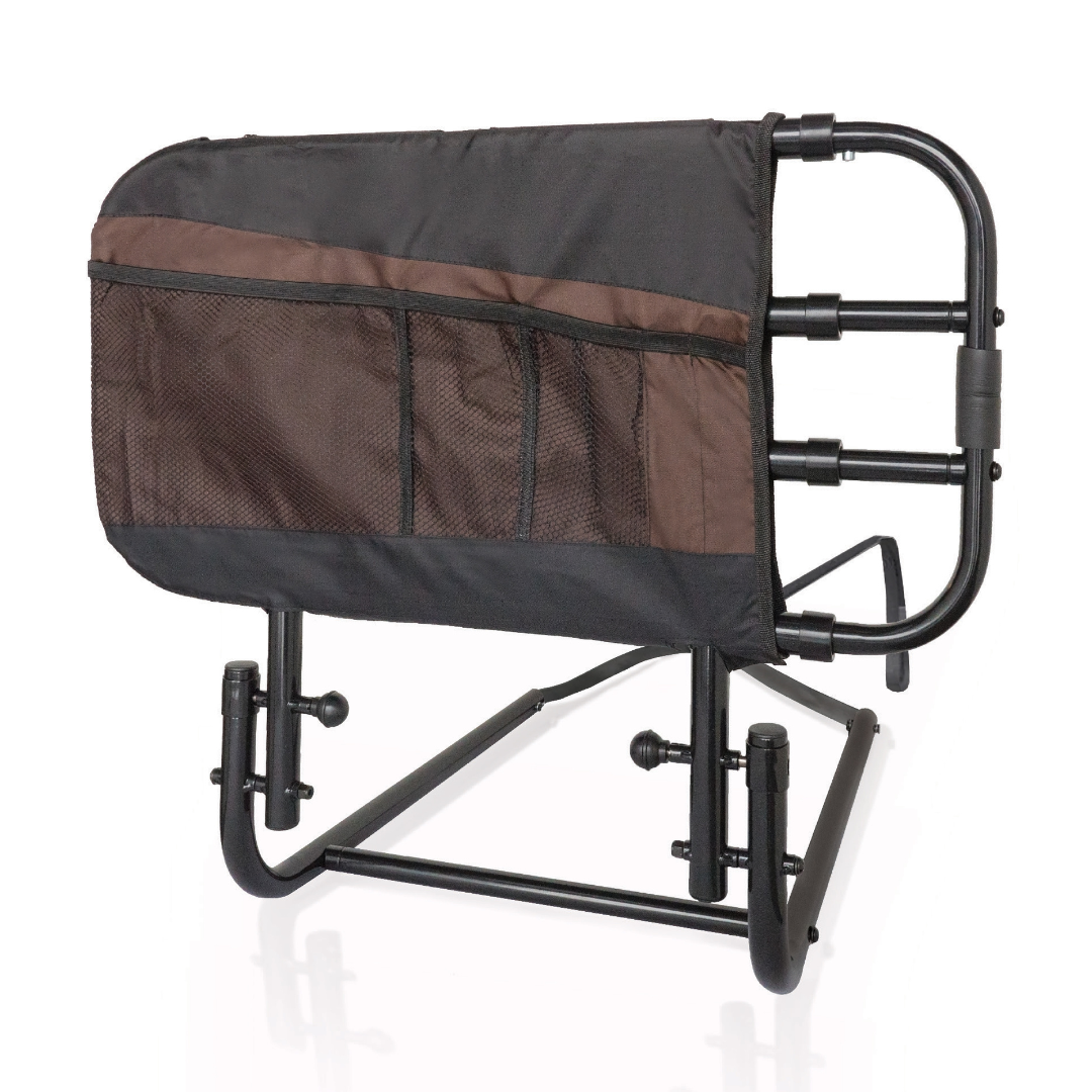 The Stander EZ Adjust Bed Rail is a black portable bed rail for adults with a brown and black multi-pocket organizer pouch, adjustable legs, and a supportive handle for fall protection.