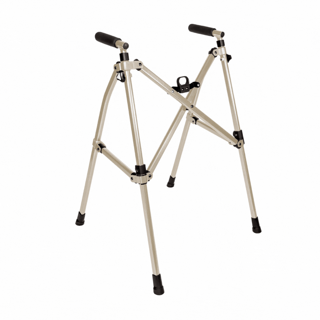 The Stander Wonder Walker Lite is a lightweight, adjustable walker with four rubber-tipped legs and black foam handles, shown against a white background.