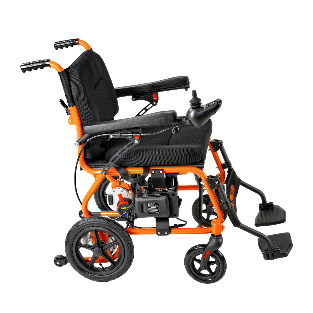 The side view of the SuperHandy GoRide 2, an orange and black motorized wheelchair at just 40 lbs, showcases padded armrests, ergonomic joystick controls, a footrest, large rear wheels, and smaller front wheels—ideal for indoor and outdoor mobility.