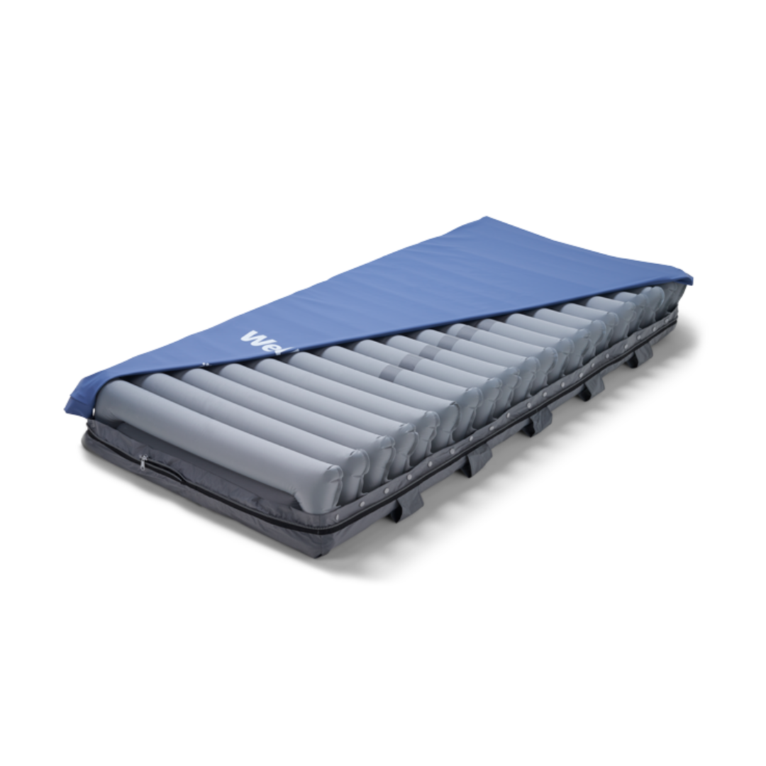 The Wellell Domus 4 Bariatric Alternating Pressure Mattress with Micro Low Air Loss is shown with a blue cover on a black base, featuring multiple long grey air cells for pressure ulcer prevention and relief.