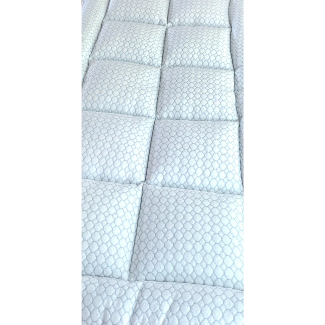 Close-up of the 2" CoolCloud™ Down Alternative Topper for Elevra beds, featuring a white, quilted hexagonal pattern with rectangular stitching. The cushioned surface is soft and hypoallergenic, perfect for added comfort.