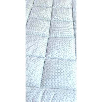 Close-up of the 2" CoolCloud™ Down Alternative Topper for Elevra beds, featuring a white, quilted hexagonal pattern with rectangular stitching. The cushioned surface is soft and hypoallergenic, perfect for added comfort.