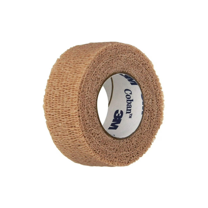 A tan 3M™ Coban™ Self-Adherent Elastic Wrap Bandage, 1” x 5 yd, is shown on a white background with visible branding on the inner core, designed for gentle compression bandaging needs.