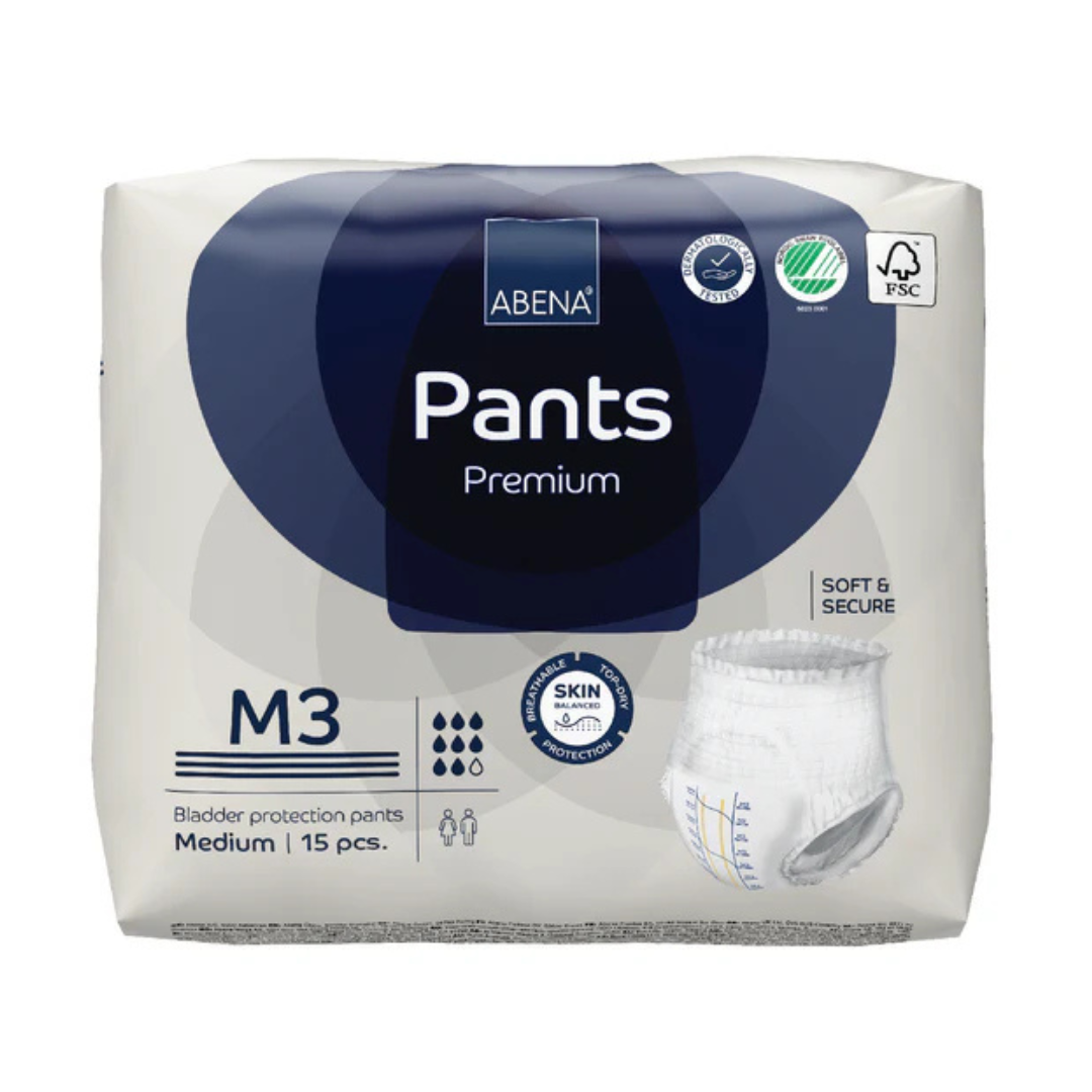 A package of Abena Pants Premium Protective Adult Underwear, medium size, includes 15 pull-up pieces in mainly white packaging with blue accents and clear product information for incontinence needs.