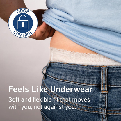 A person lifts a blue shirt to show the waistband of Abena Pants Premium Protective Adult Underwear above blue jeans. Text: Feels Like Underwear—soft, flexible fit with absorbent protection and odor control. Odor Control badge visible.
