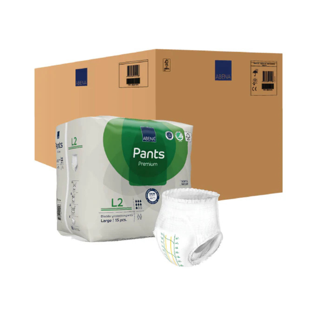 A pack and a single disposable Abena Pants Premium Protective Adult Underwear are displayed in front of a large brown cardboard box. Each pack contains 15 large-sized pull-up underwear for comfortable incontinence protection.