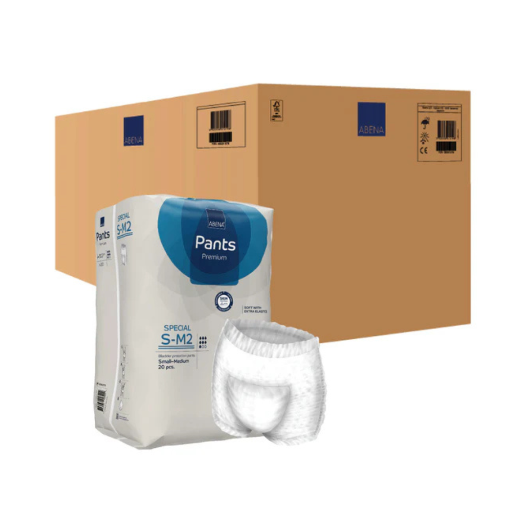 A pack of Abena Pants Premium Protective Adult Underwear is shown in front of a large brown shipping box, with one individual underwear beside the pack for convenient incontinence protection.