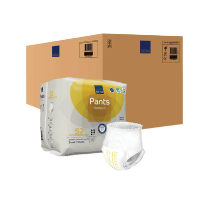 A large brown shipping box sits behind a package of Abena Pants Premium Protective Adult Underwear. One pull-up is displayed in front, showing its waistband and sides designed for comfortable, discreet incontinence protection.