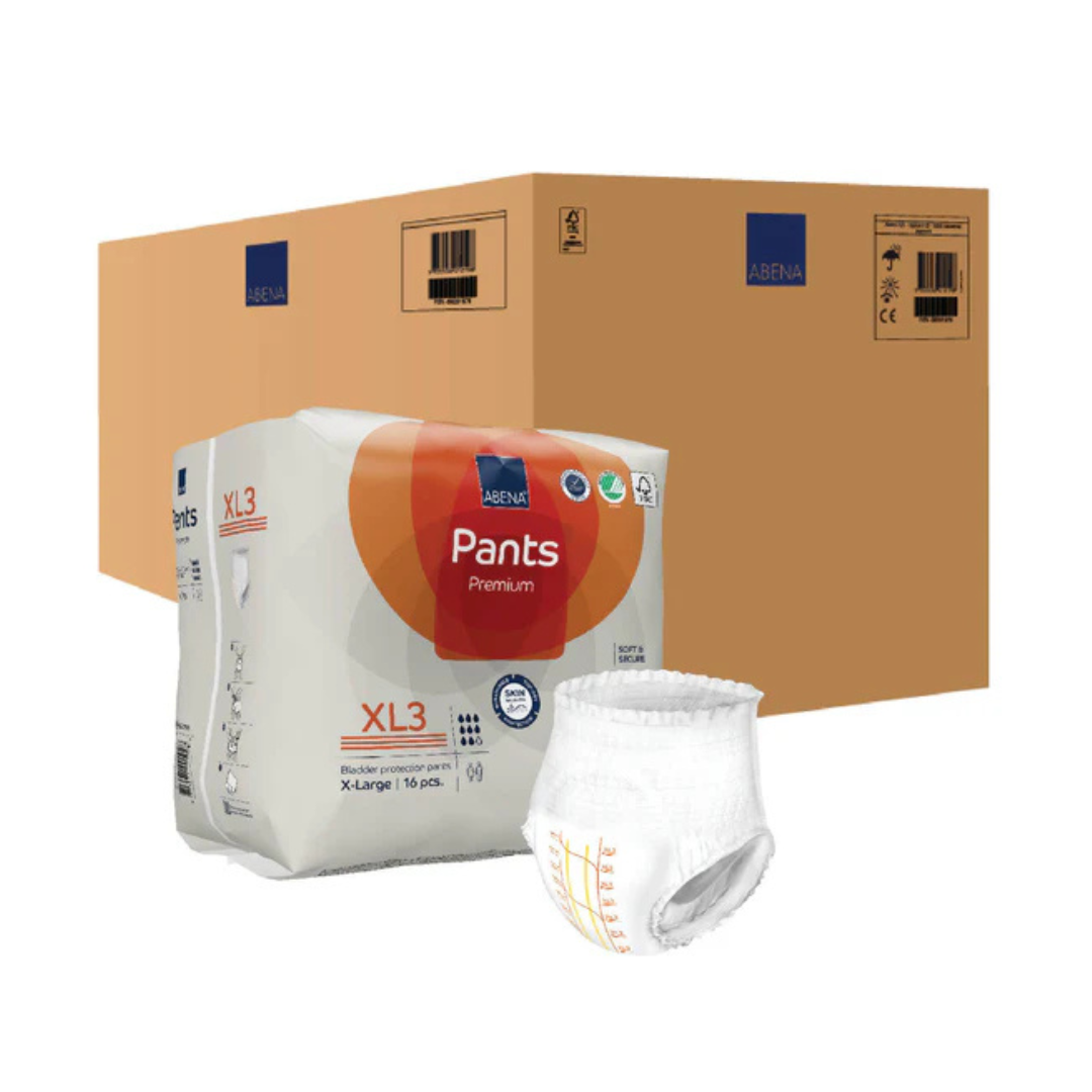 A package of Abena Pants Premium Protective Adult Underwear, a single adult diaper for incontinence protection, and a large brown shipping box in the background.