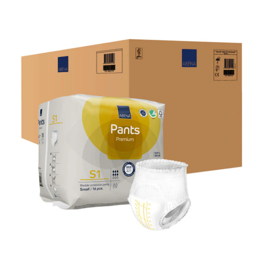 A box of Abena Pants Premium Protective Adult Underwear sits before a large brown shipping box, with one underwear displayed outside to showcase its design, waistband, and reliable incontinence protection.
