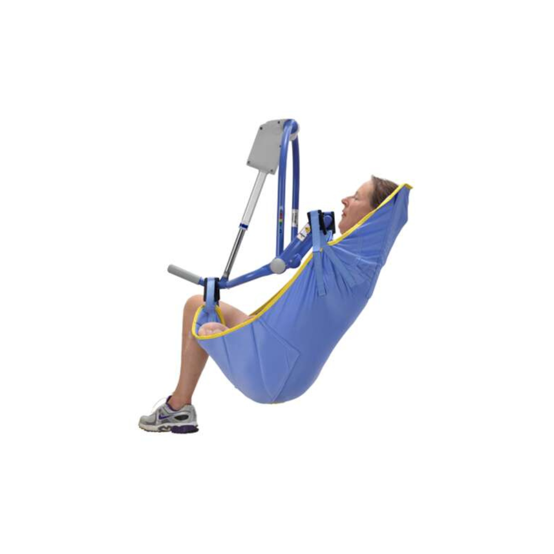 A person sits in an ARJO 4-Point Spreader Sling for patient lifts, supported by a metal frame, with their legs hanging out and feet resting on the ground.