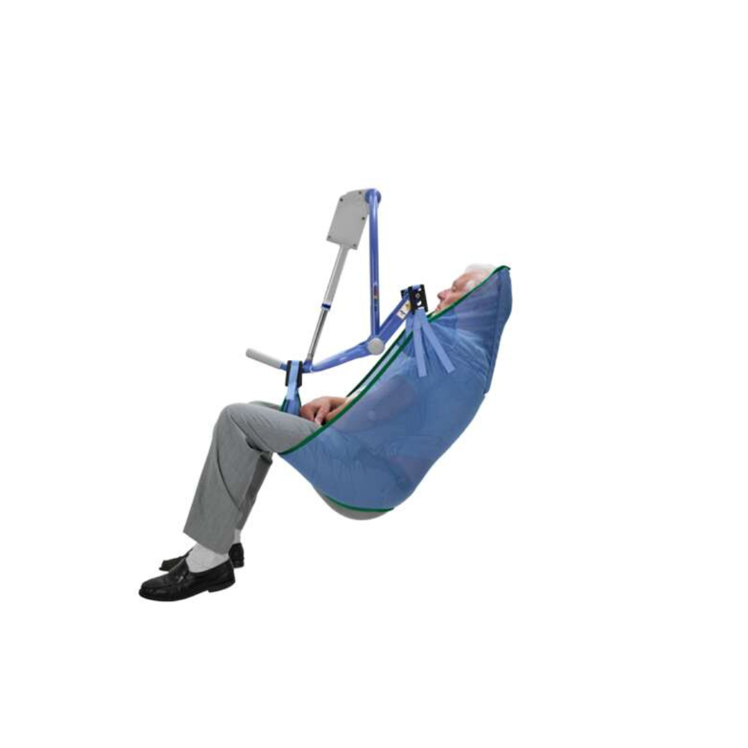 An older man in a suit is safely supported off the ground by an ARJO 4-Point Spreader Sling for Patient Lifts, sitting in a blue and green padded leg sling. The background is plain white.
