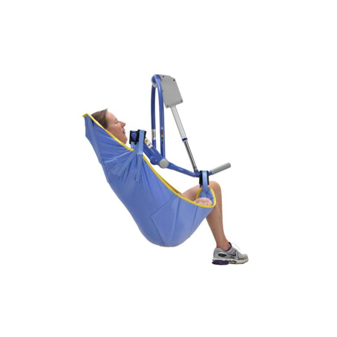 A person is comfortably seated in an ARJO 4-Point Spreader Sling for Patient Lifts, with head support and legs relaxed, suspended by a metal frame while wearing a white shirt and sneakers.