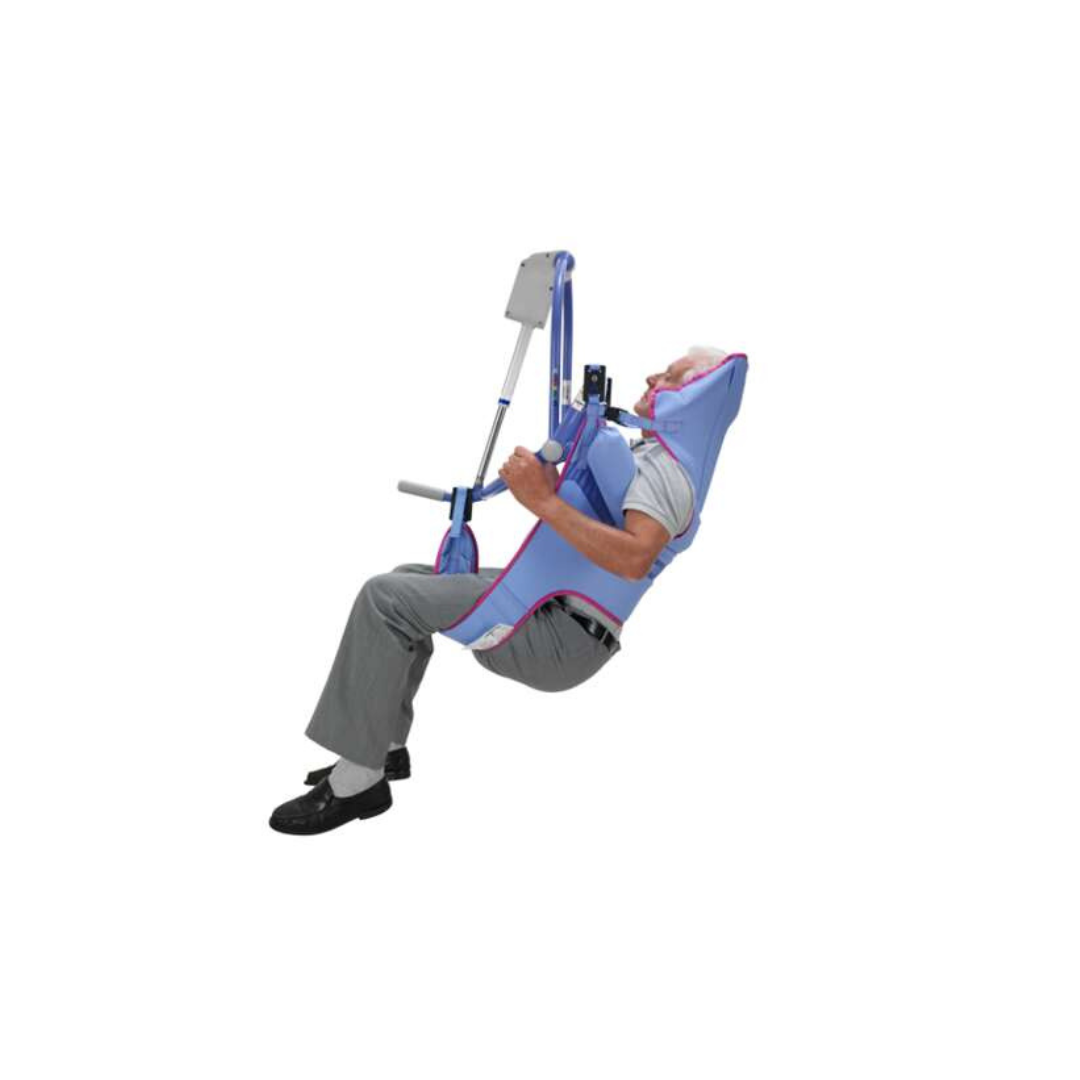 An older adult is seated in an ARJO 4-Point Spreader Sling for Patient Lifts, attached to a floor lift for safe transfer or support, with feet slightly off the ground and arms resting comfortably on the sling.