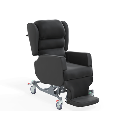 The Accora Configura® Advance Postural Tilt Chair is a black, cushioned chair with armrests, high back, wheeled base, and extended footrest—designed for mobility and patient comfort.