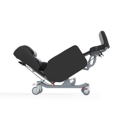 The Accora Configura® Advance Postural Tilt Chair, shown in black with padded sections and wheels, is displayed in a reclined position on a white background.