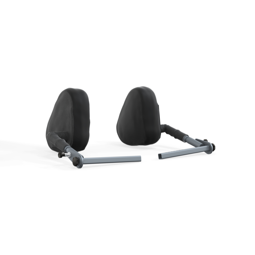 Two black cushioned headrests with metal support bars, designed for the Accora Configura® Advance Postural Tilt Chair, are positioned side by side on a white background and angled slightly outward.