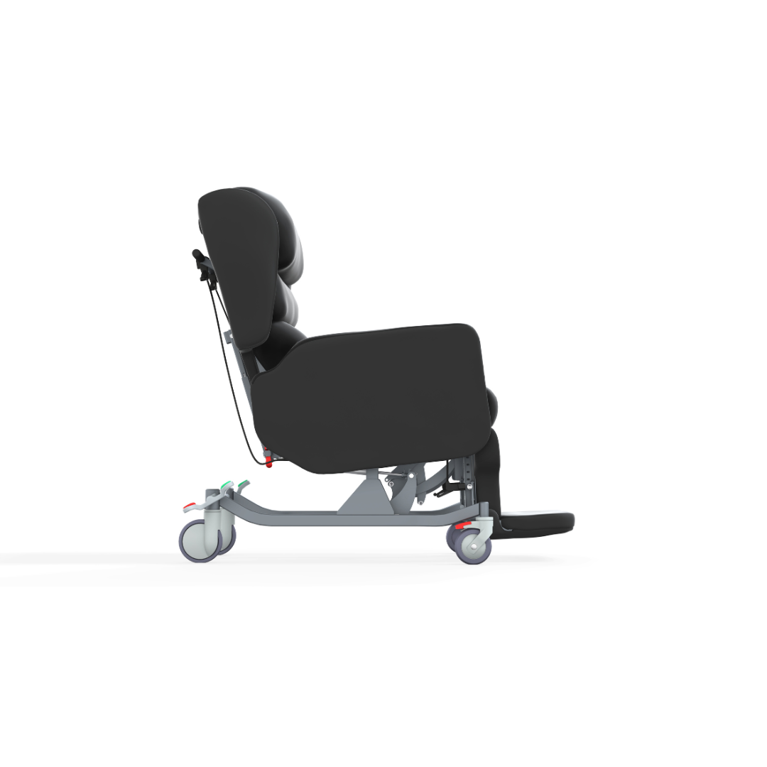 Side view of the Accora Configura® Advance Postural Tilt Chair in black, featuring cushions, wheels, and a footrest for patient comfort and mobility, displayed against a white background.
