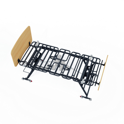 The Accora Contesa® FloorBed® Hi/Low Full Electric Bed, a black metal adjustable hospital bed frame with rolling wheels and wooden headboard and footboard for fall prevention, is shown from a high angle on a white background.