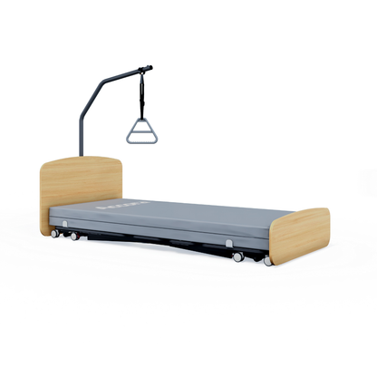 The Accora Contesa® FloorBed® Hi/Low Full Electric Bed features a wooden headboard/footboard, gray mattress, wheels, and an overhead trapeze bar with triangular handle for smart patient support and fall prevention.