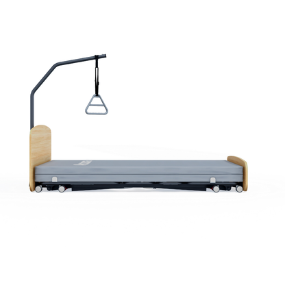 The Accora Contesa® FloorBed® Hi/Low Full Electric Bed features light wood accents, a gray mattress, wheels, and an overhead trapeze with a triangular hand grip—an ideal fall-prevention solution shown against a white background.