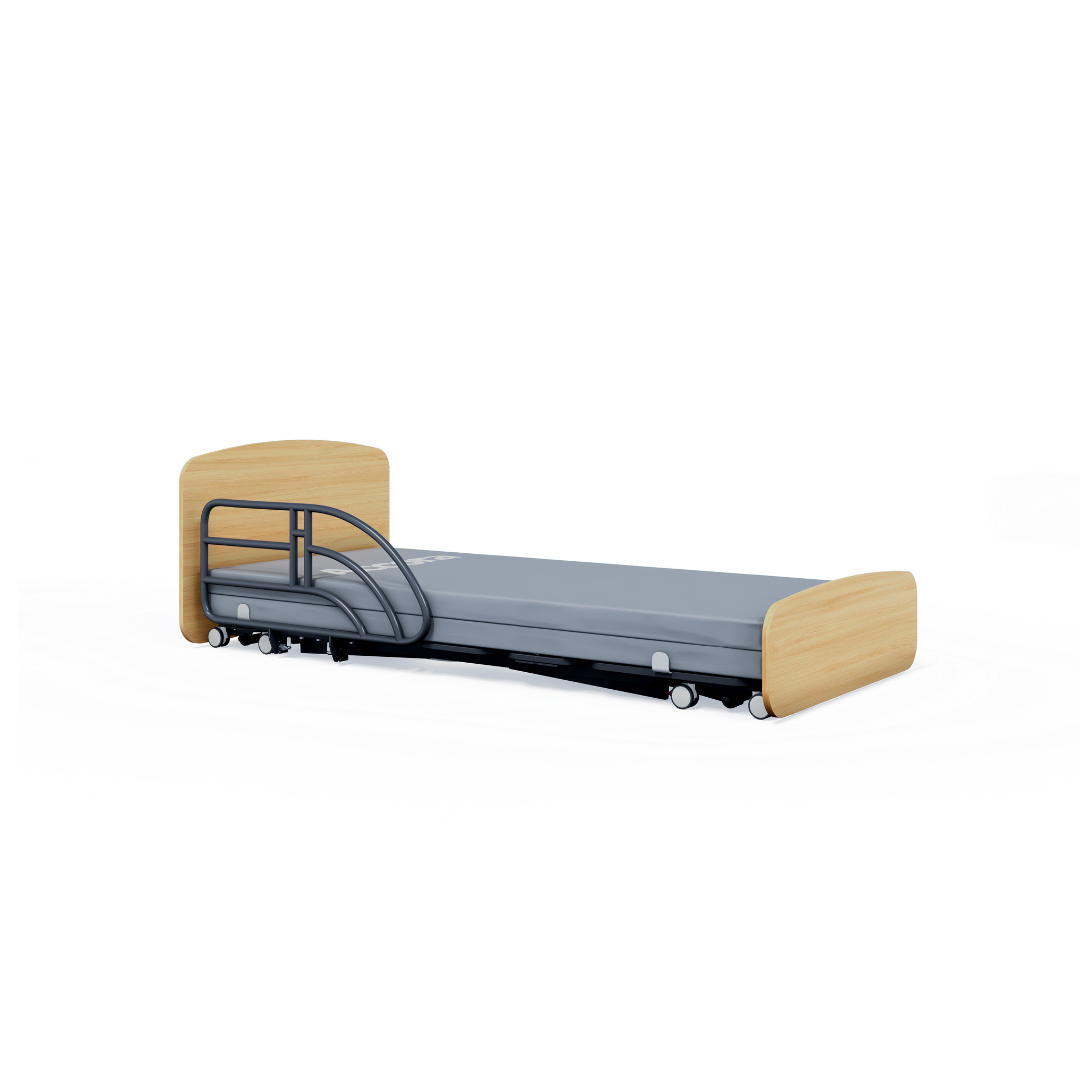 An Accora Contesa® FloorBed® Hi/Low Full Electric Bed with light wood head/footboards, grey mattress, single metal safety rail, and wheels—an ideal fall-prevention solution shown on a plain white background.