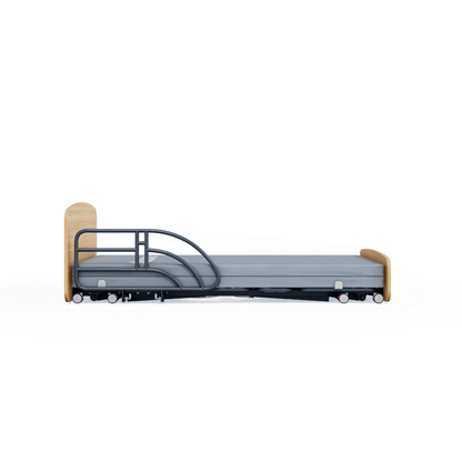 The Accora Contesa® FloorBed® Hi/Low Full Electric Bed features light wood head and footboards, side rails, and wheels. Shown from the side on a white background, it offers an effective fall-prevention solution for patient safety.