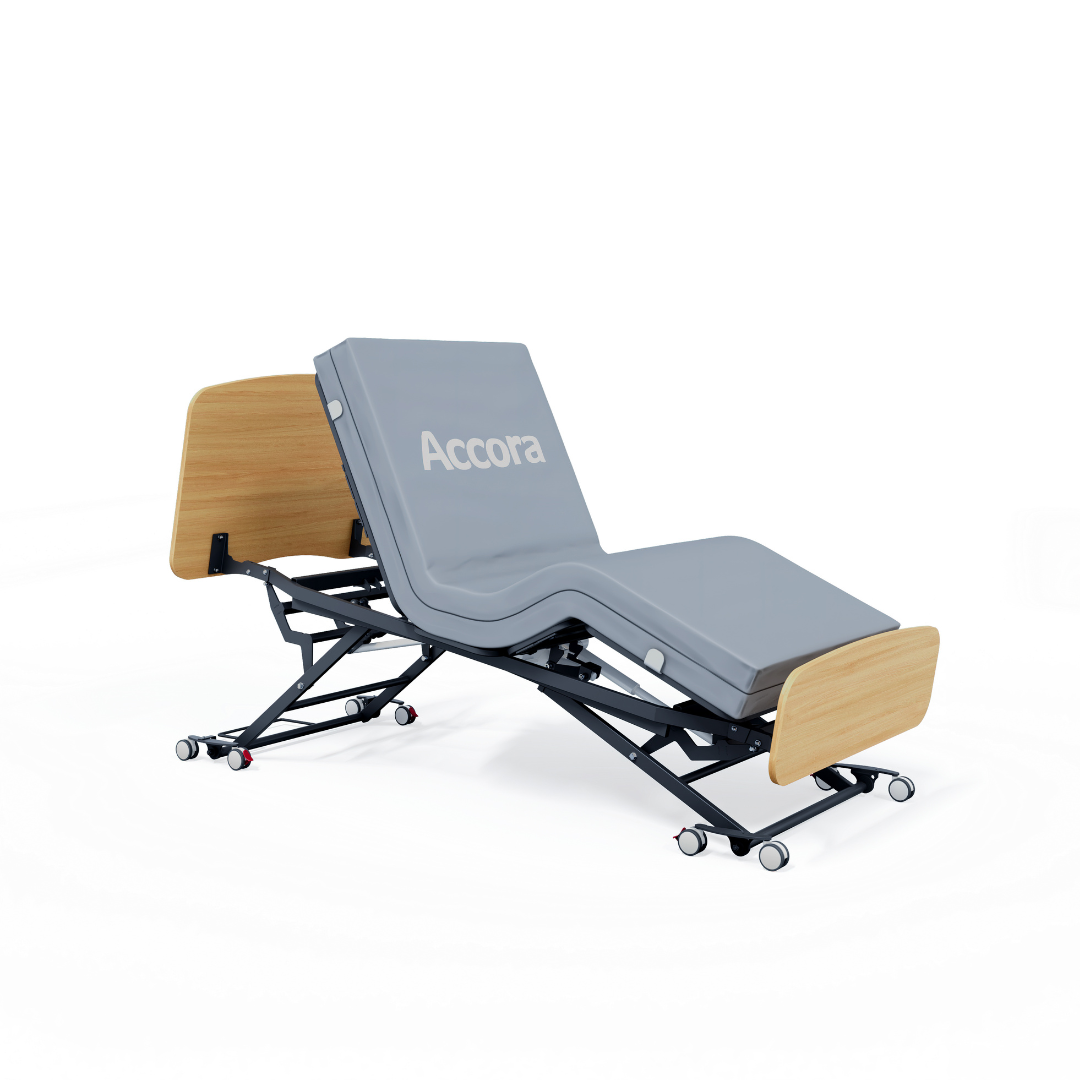The Accora Contesa® FloorBed® Hi/Low Full Electric Bed features a gray mattress, light wood head and footboard, black wheeled metal frame, partial elevation, and "Accora" on the backrest—an ideal solution for fall prevention.